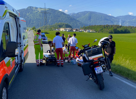 Rettungskräfte leisten Erste Hilfe an einem Unfallopfer auf der Straße.